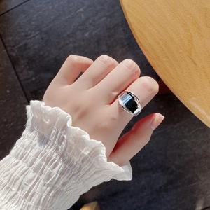 Macro shot of minimalist S925 sterling silver wide ring with black rectangular inlay on finger