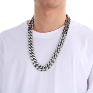 Silver stainless steel Cuban link chain necklace shown on a model wearing a white T-shirt