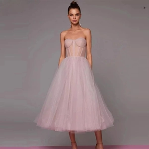 Elegant strapless tulle corset midi dress in soft pink with voluminous A-line skirt