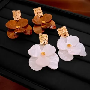 Maillard style flower petal drop earrings with gold square studs on black velvet tray