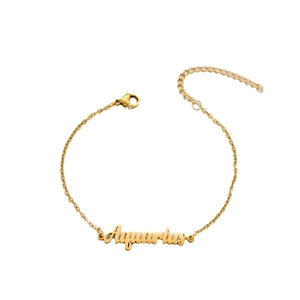 Golden Aquarius zodiac chain bracelet with cursive lettering and lobster clasp closure