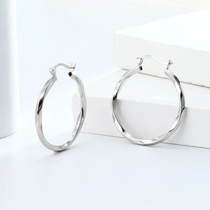 Macro detail of S925 sterling silver stamp on the twisted hoop earring buckle