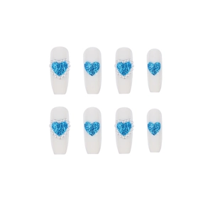 Long trapezoid press-on nails with white base, blue glitter hearts and pearl accents