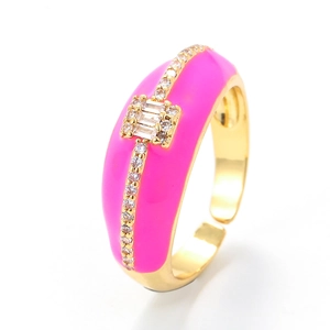 Adjustable gold ring with bright pink enamel and sparkling zircon accents on white background