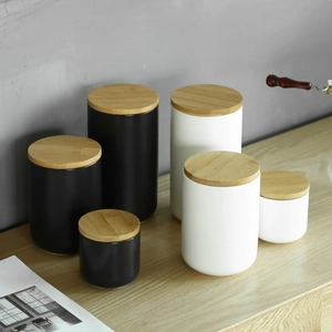 Minimalist ceramic storage canisters with bamboo lids for coffee beans and tea leaves