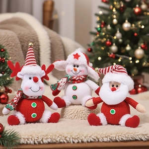 Knitted Christmas dolls including Santa, snowman and reindeer on a warm festive rug