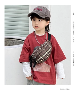 Detail of child wearing vintage plaid chest bag with adjustable strap and rope zipper pull