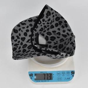 Detail shot of lightweight leopard print corduroy baseball cap weighing 77.3g on scale