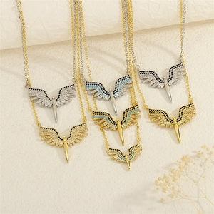 Detailed close-up of angel wing necklaces with micro-pave cubic zirconia and O-chains