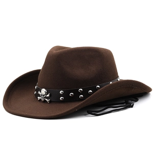 Detail of western felt hat with leather band featuring silver skull emblem and metal studs