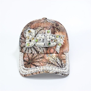 Detail of floral baseball cap with Baby lettering in rhinestones and pearls decoration