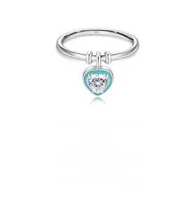 Macro detail of S925 sterling silver ring with blue enamel heart and zircon pendant