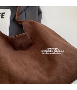 Detail of soft dark brown suede tote bag featuring a minimalist lightweight design