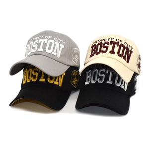 Detail view of four cotton baseball caps featuring 3D Boston embroidery in multiple colors