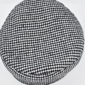 Detailed top view of a classic black and white houndstooth baker boy cap and visor