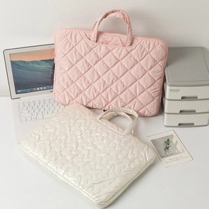 Quilted laptop sleeve bag in pink and beige colors with heart pattern and diamond stitching