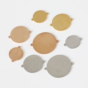 Detailed view of polished stainless steel round tags in gold, silver and rose gold colors