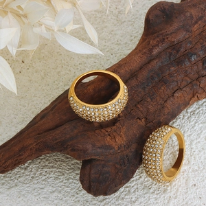 Luxurious French style gold titanium steel rings with Czech crystals on dark wood background