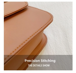 Detailed close-up of precise stitching on a brown leather vintage saddle bag