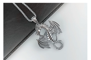 Macro shot of silver dragon pendant with detailed scales and sturdy metal chain