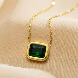 Close-up of emerald green square zircon pendant on a gold stainless steel chain