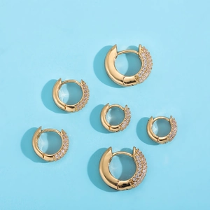 Set of six gold-plated hoop earrings with micro-pave cubic zirconia on blue background