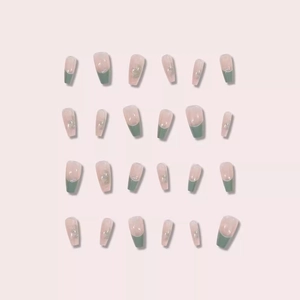 Pink mid-length ballerina press-on nails with green French tips and 3D floral accents