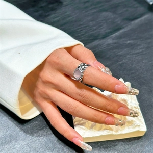 Irregular silver stainless steel open ring with round pink gemstone on elegant hand