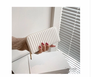 Detailed view of a white quilted PU leather long wallet with elegant gold zipper hardware