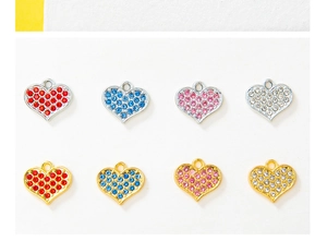 Macro shot of assorted heart-shaped rhinestones in gold and silver metal charms
