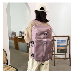 Lavender waterproof nylon travel backpack with adjustable straps and side pockets on model