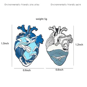 Blue ocean wave and whale anatomical heart enamel brooches with size measurements