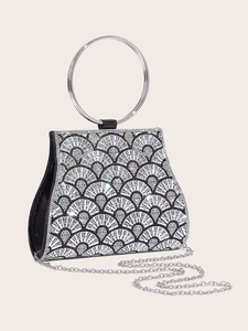 Close-up of black diamond evening clutch with silver ring handle and chain strap details