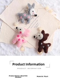 Close-up of handmade wool felt reindeer charms with warm LED string lights and festive decor
