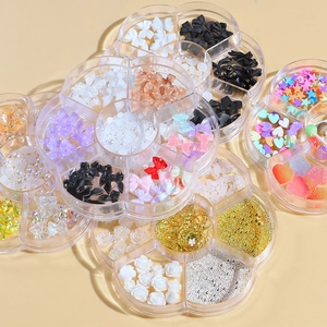 Assorted nail art charms with resin bows, pearls and metal chains in floral cases