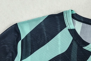 Detail of sheer mesh crew neck top with mint green and black diagonal striped pattern