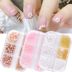 Mix of colorful round pearls and gold beads for nail art DIY in multi-size boxes