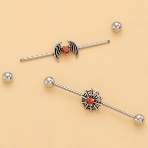 Detail view of steel industrial barbells with red heart, wings, and spider web designs