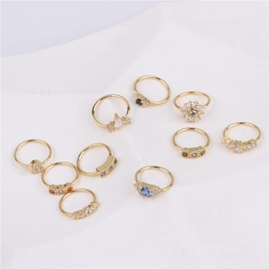 Set of ten 18K gold plated nose rings with colorful zircon inlays on white fabric