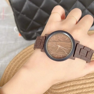 Women's casual wristwatch with a large tortoiseshell wood grain dial and brown strap