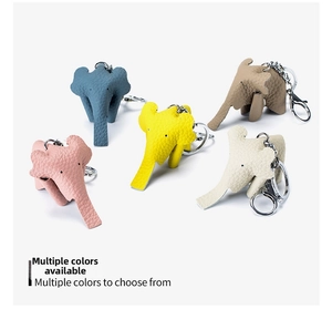 Detailed close-up of elephant leather keychains in five pastel colors with metal hardware