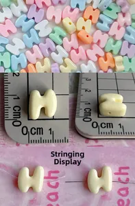 Macro detail of 10mm macaron letter H resin beads for DIY jewelry making and phone chains