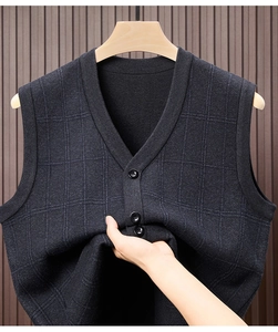 Detail of dark grey plaid knit vest featuring V-neckline and high-quality buttons