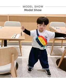 Action shot of child wearing a colorful cartoon bus-shaped mini crossbody bag