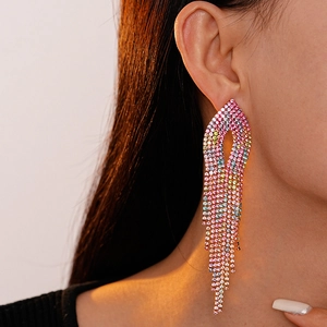 Close-up of elegant gradient crystal fringe earrings on model with warm sunlight