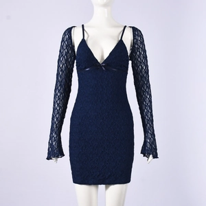 Close-up of dark blue lace texture on mini dress with long sleeve shrug overlay