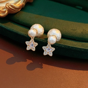 Macro view of 18K gold plated cotton pearl star earrings with micro-inlaid zircon details