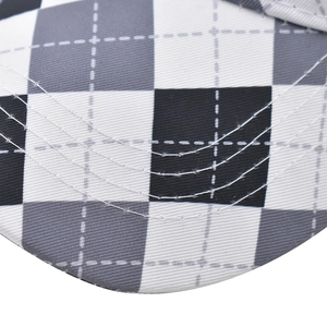 Macro detail of diamond pattern stitching and twill fabric texture on a baseball cap brim
