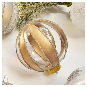 Detail of transparent Christmas ball with champagne gold glitter spiral and metallic cap