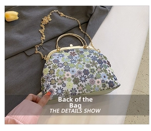 Detail showing vintage floral canvas bag with golden metal handles and chain strap